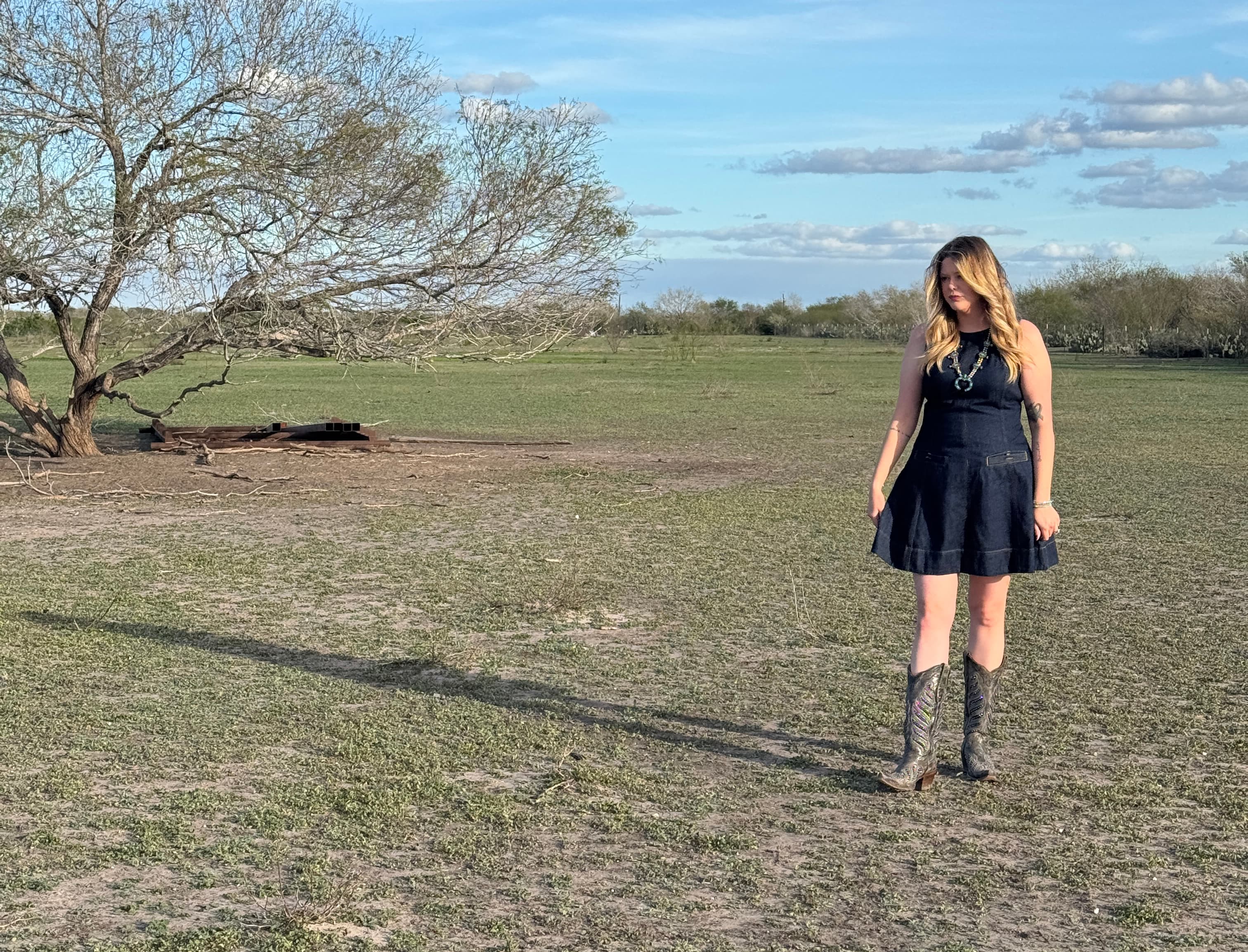 Rachael standing in an open Texas field